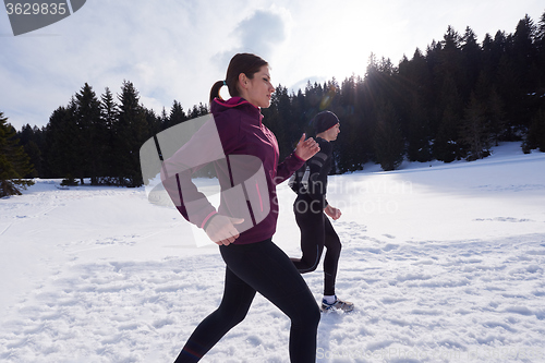 Image of couple jogging outside on snow