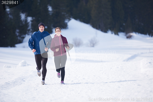 Image of couple jogging outside on snow