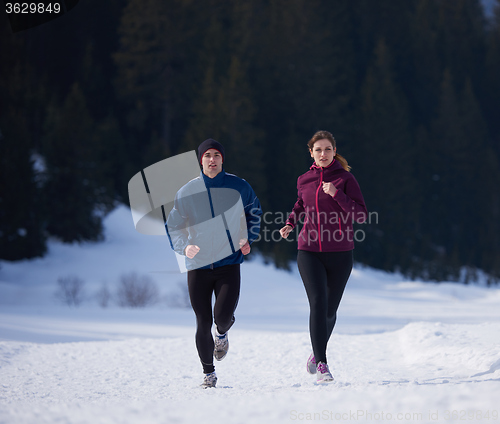 Image of couple jogging outside on snow