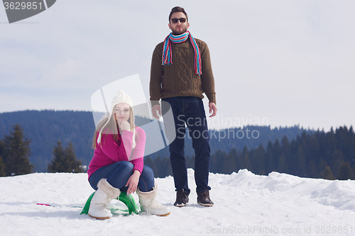 Image of happy young couple having fun on fresh show on winter vacation