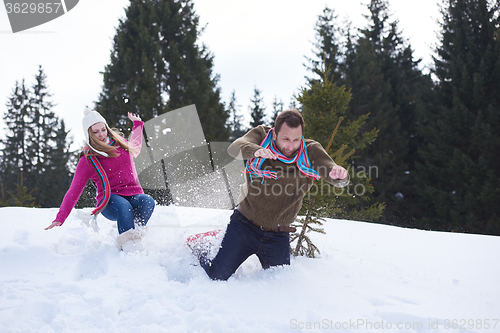 Image of couple having fun and walking in snow shoes