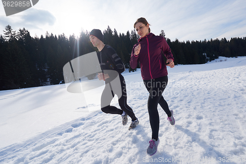 Image of couple jogging outside on snow