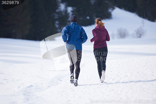 Image of couple jogging outside on snow