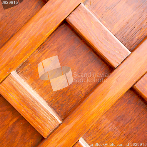 Image of home texture of a brown antique wooden old door in italy   europ