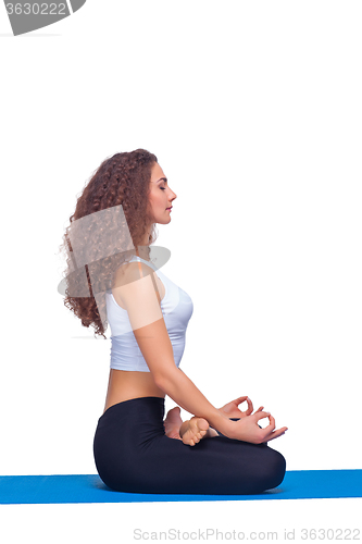 Image of Studio shot of a young fit woman doing yoga exercises.