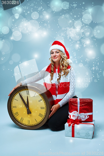 Image of Girl dressed in santa hat with a Christmas decorations  