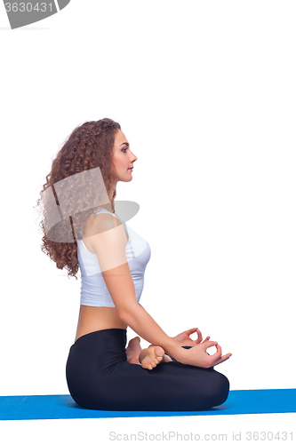 Image of Studio shot of a young fit woman doing yoga exercises.