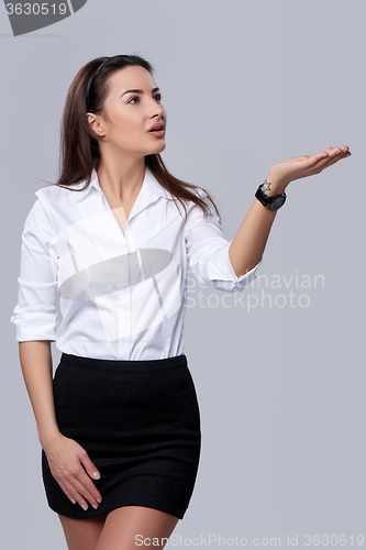 Image of business woman blowing on palm