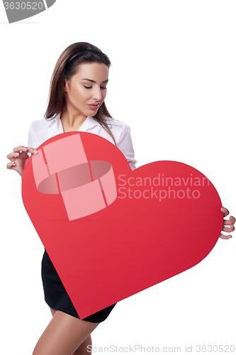 Image of Woman holding big red heart shape banner