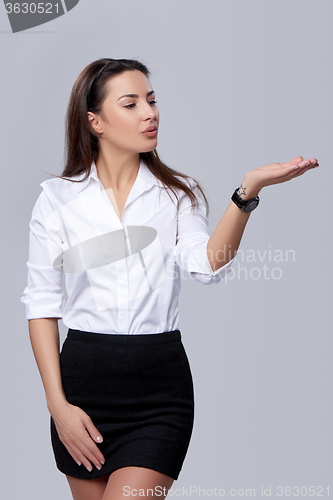 Image of business woman blowing on palm