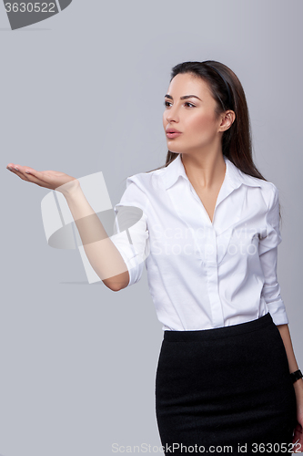 Image of business woman blowing on palm