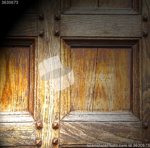 Image of abstract texture of a brown antique wooden old door in italy   e