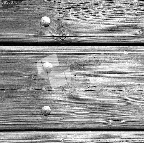 Image of abstract texture of a brown antique wooden old door in italy   e