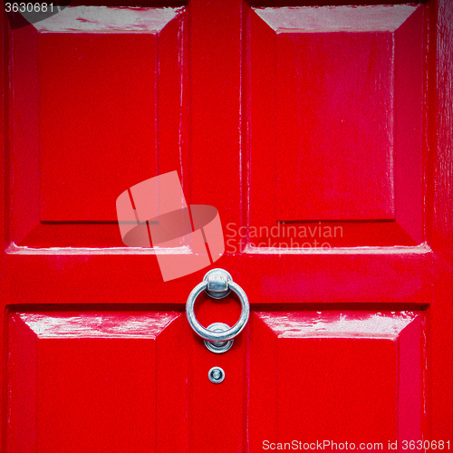 Image of red handle in london antique brown door  rusty  brass nail and l