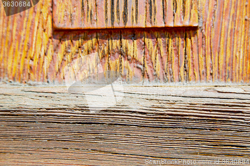 Image of grain texture of a brown antique wooden old door in italy   euro