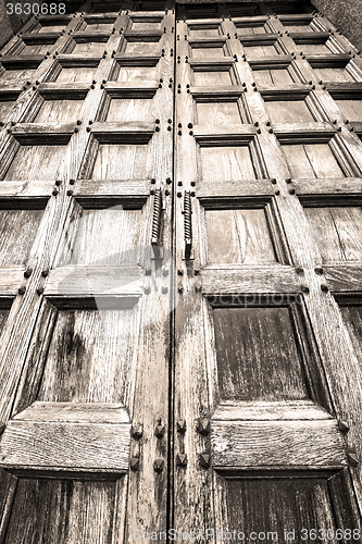 Image of abstract texture of a brown antique wooden old door in italy   e
