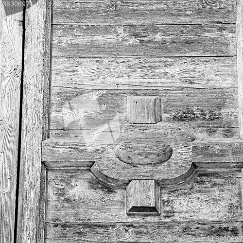 Image of grain texture of a brown antique wooden old door in italy   euro