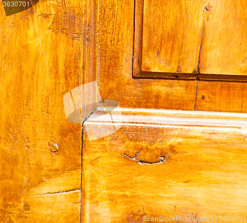 Image of grain texture of a brown antique wooden old door in italy   euro
