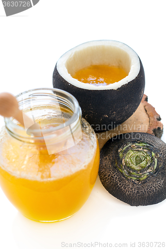 Image of Black radish and a jar of honey.