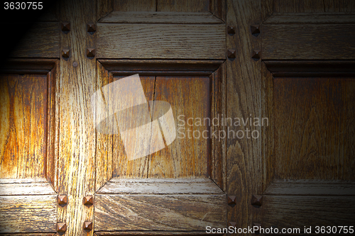 Image of abstract texture of a brown antique wooden old door in italy   e