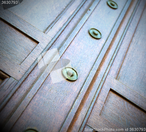 Image of in london antique brown door  rusty  brass nail and light