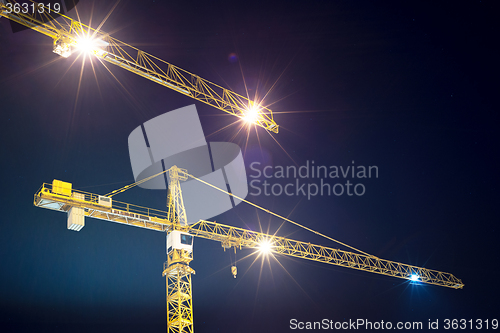 Image of cranes and illumination at night