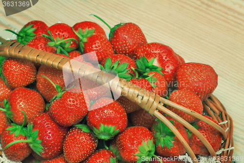 Image of Basket of strawberries on the table surface.