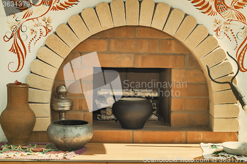 Image of A model of an old stove and antique dishes.