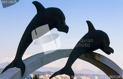 Image of Sculptures of dolphins in the sky.