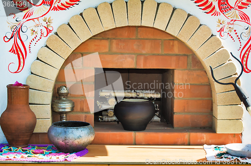 Image of A model of an old stove and antique dishes.