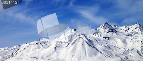 Image of Panoramic view of winter snowy mountains at windy day