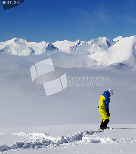 Image of Snowboarder on off-piste slope with new fallen snow