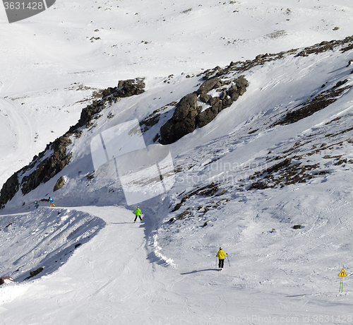 Image of Snowboarders and skiers on groomed slope