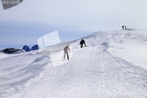 Image of Skiers on ski slope at wind day