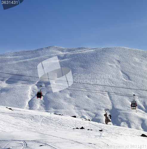 Image of Gondola lifts and ski slope at nice sun morning