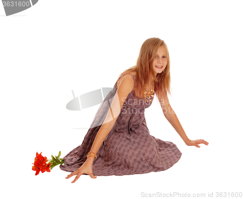 Image of Beautiful little girl sitting on floor.