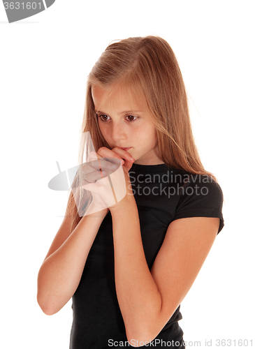 Image of Girl standing in profile and praying.