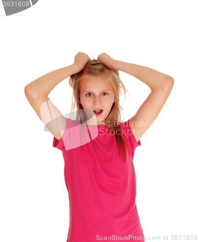 Image of Pretty blond girl pulling her hair.