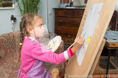 Image of A girl studying painting in the artist\'s studio