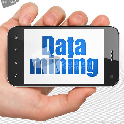 Image of Data concept: Hand Holding Smartphone with Data Mining on display