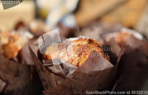 Image of Fresh baked muffins lightly dusted with icing sugar