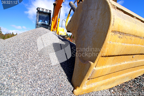 Image of excavator against blue sky    