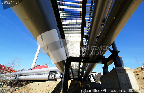 Image of Industrial zone, Steel pipelines and valves against blue sky