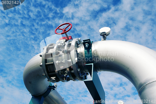 Image of Industrial zone, Steel pipelines and valves against blue sky