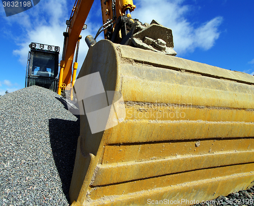 Image of excavator against blue sky