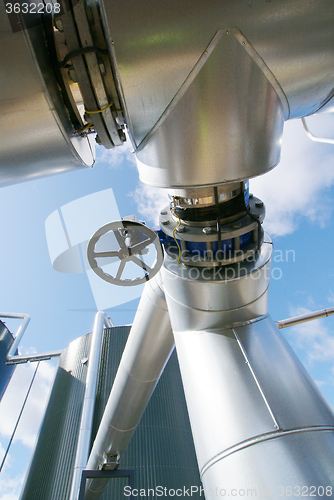 Image of Industrial zone, Steel pipelines and valves against blue sky