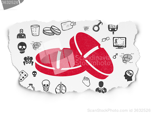 Image of Medicine concept: Pills on Torn Paper background