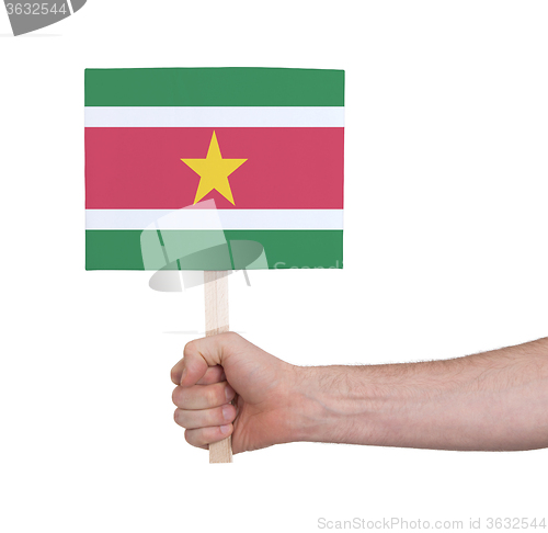 Image of Hand holding small card - Flag of Suriname