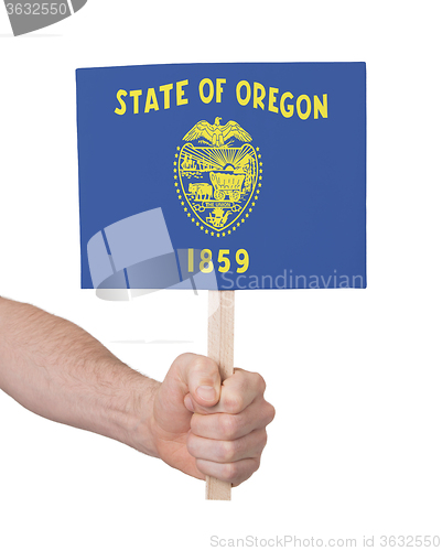 Image of Hand holding small card - Flag of Oregon