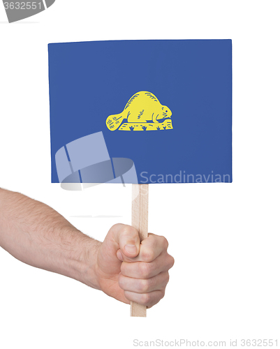 Image of Hand holding small card - Flag of Oregon